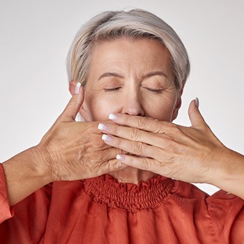 Lady covers mouth with hands?