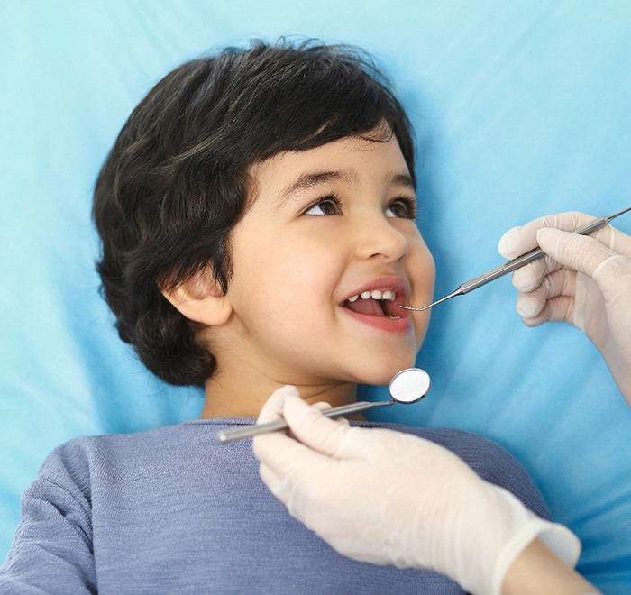 little boy getting a dental examination