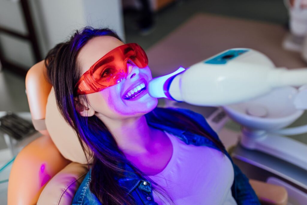 A woman getting a professional teeth whitening treatment.